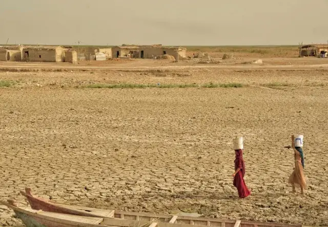 Two girls transport the remaining drinking water